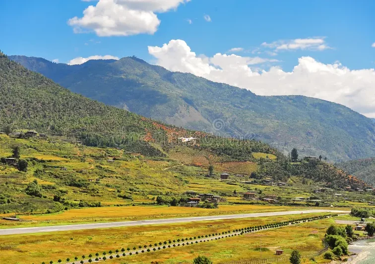 panoramic-view-airport-paro-valley-bhutan-landscape-mountain-river-green-meadows-agricultural-land-blue-sky-301823571