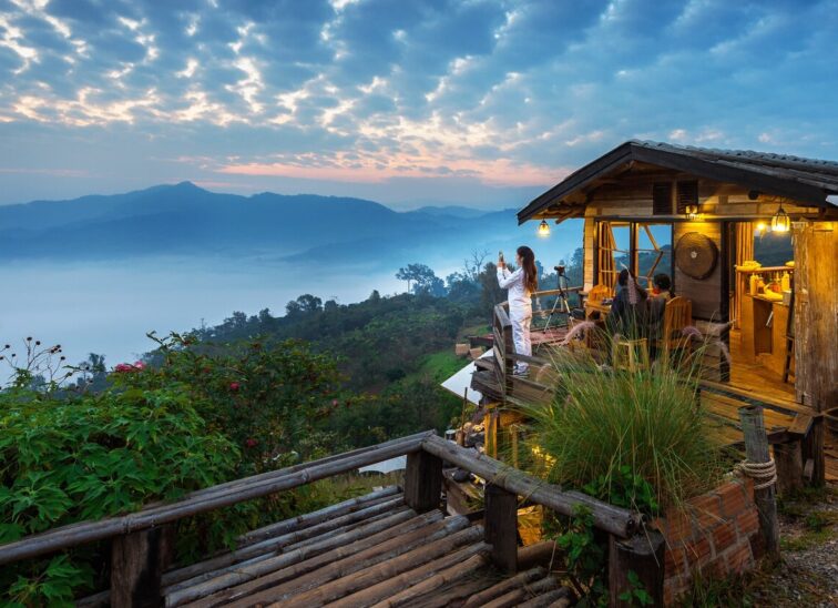woman-taking-photo-morning-mist-phu-lang-ka-phayao-thailand_335224-950